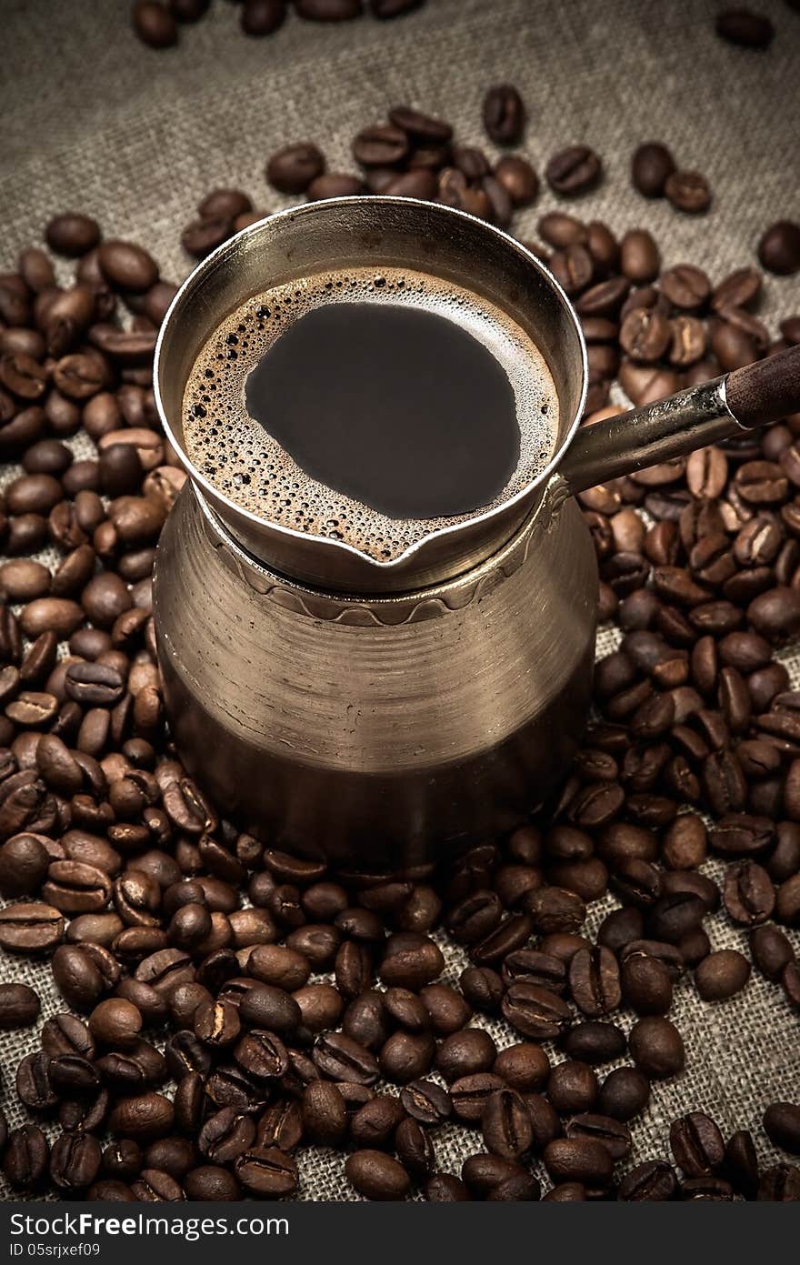 Coffee in a cezve and coffee beans