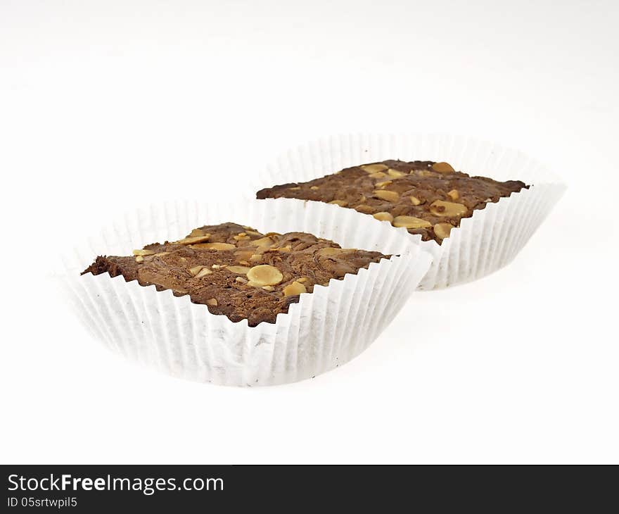 Set of almonds brownies in white peper cup on white background. Set of almonds brownies in white peper cup on white background