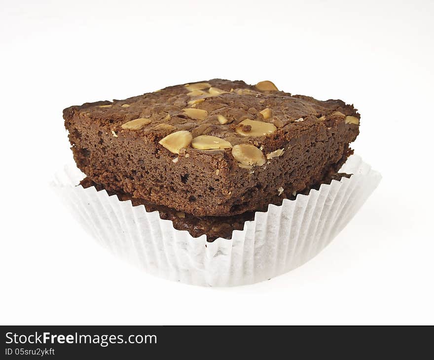 Double almonds brownies in paper cup on white background. Double almonds brownies in paper cup on white background