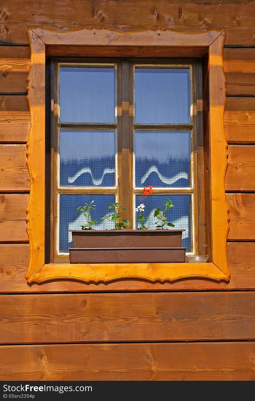 Window of wooden cottage close up