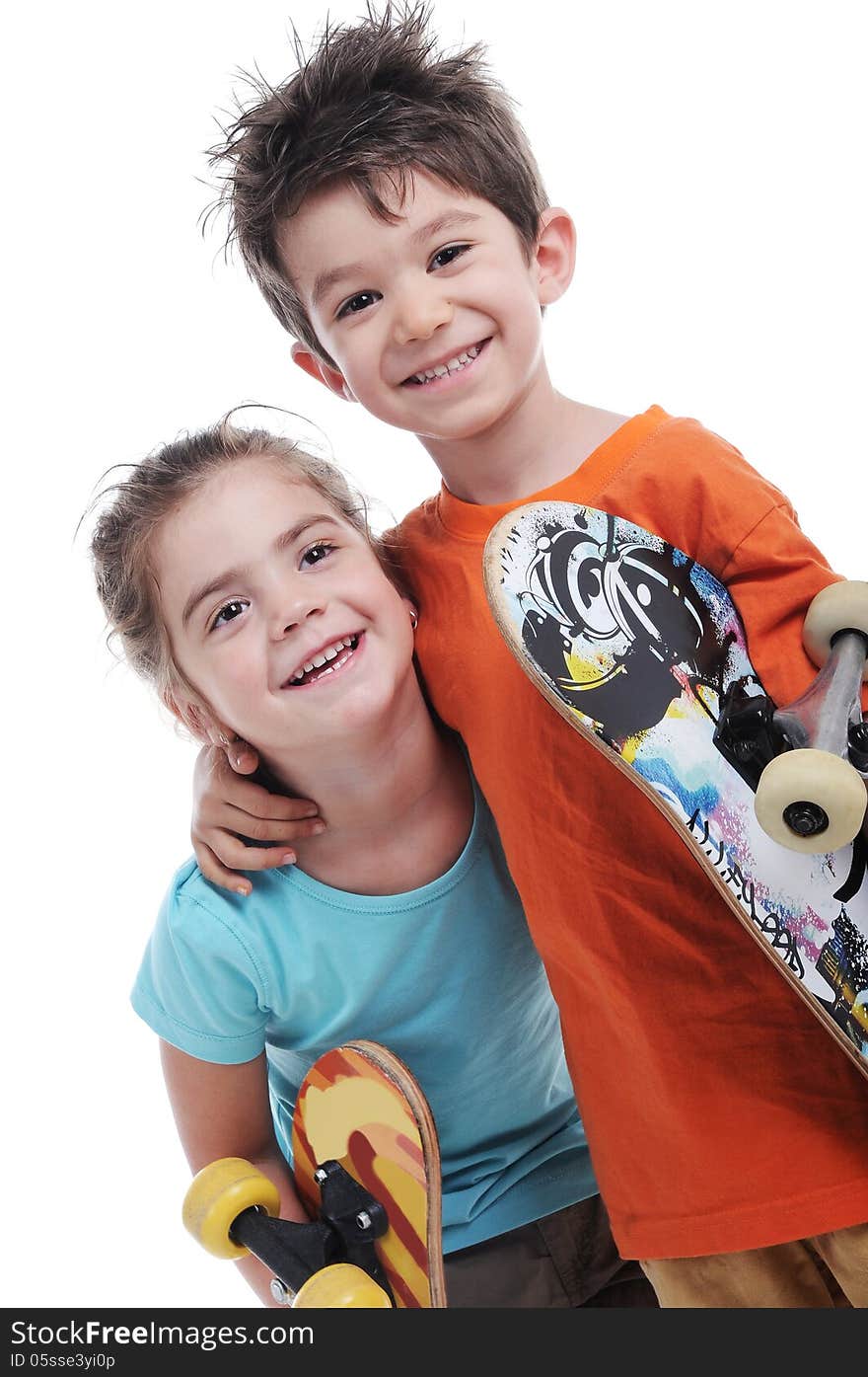 Photography of cute boy and girl are carring skate boards close up in studio shot. Photography of cute boy and girl are carring skate boards close up in studio shot