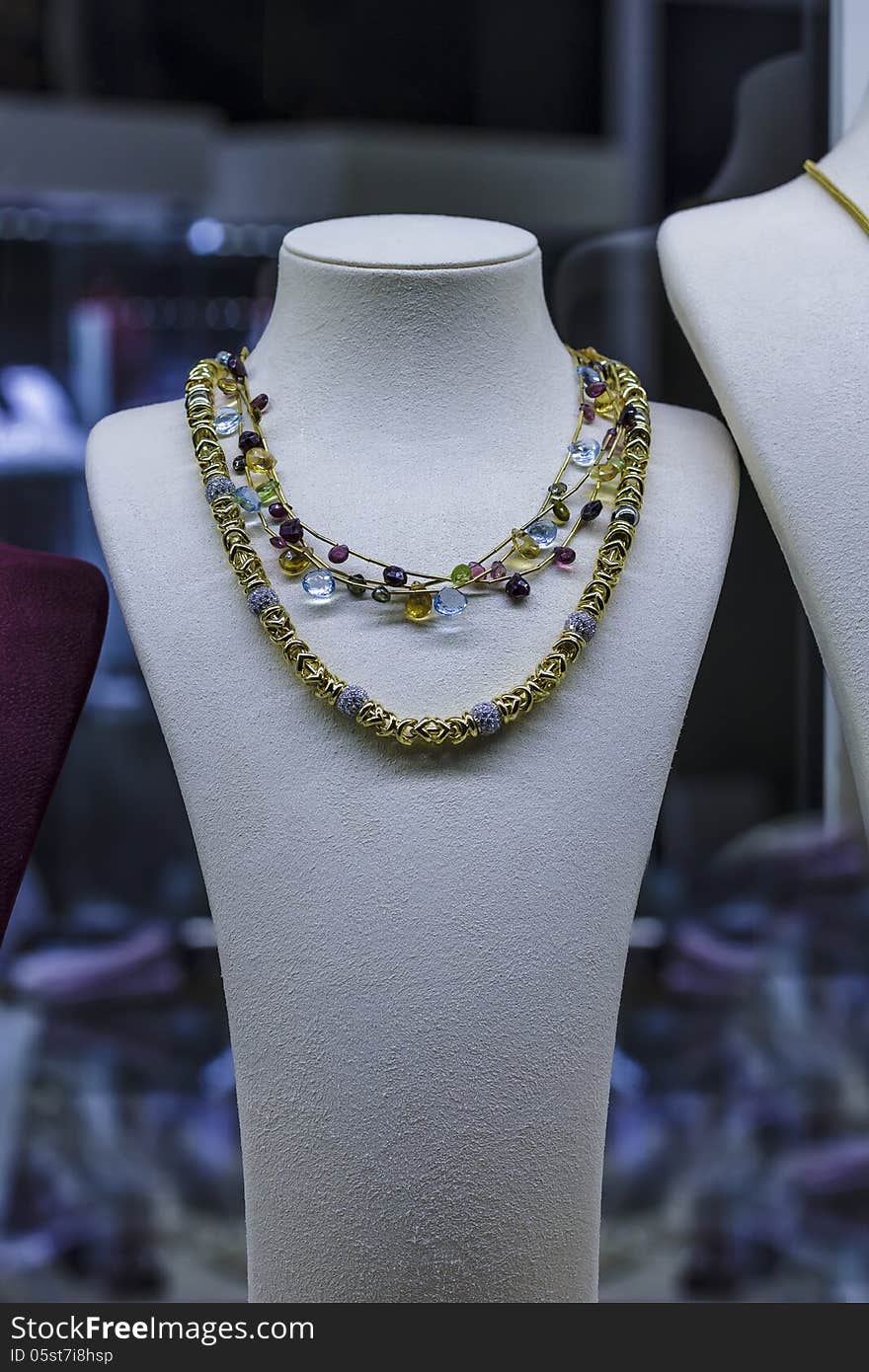 Golden necklace on jewellery showcase in jewellery shop. Golden necklace on jewellery showcase in jewellery shop