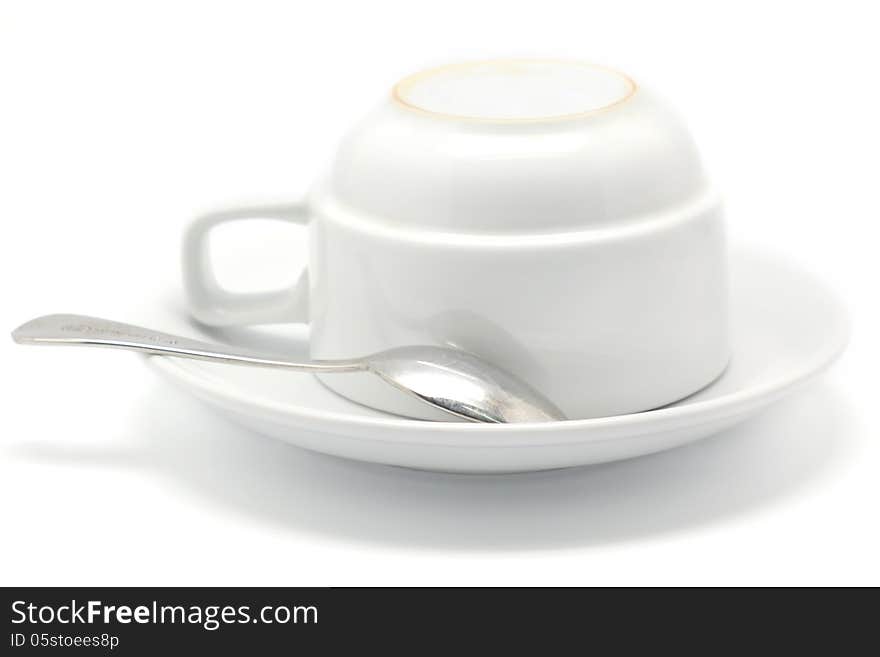 Empty coffee cup and spoon Isolated on white background