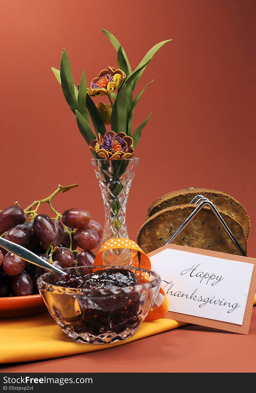 Happy Thanksgiving day breakfast or morning brunch with toast, jelly and grapes - vertical.