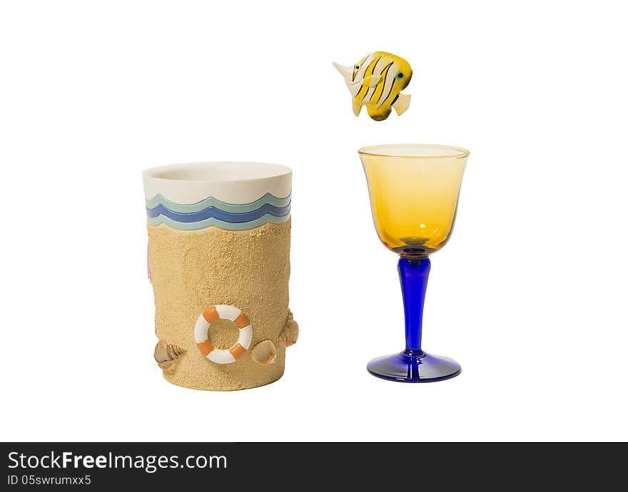 Yellow fish jump out of wine glass into beach cup isolated on white background. Yellow fish jump out of wine glass into beach cup isolated on white background