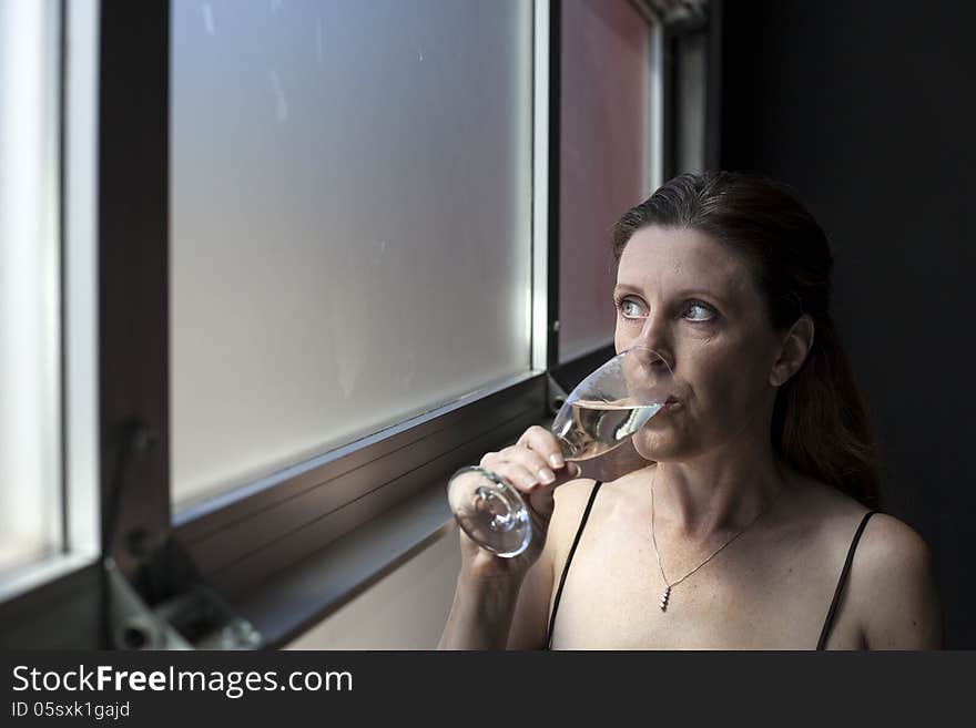 Middle Aged Woman in Black Dress with Champagne