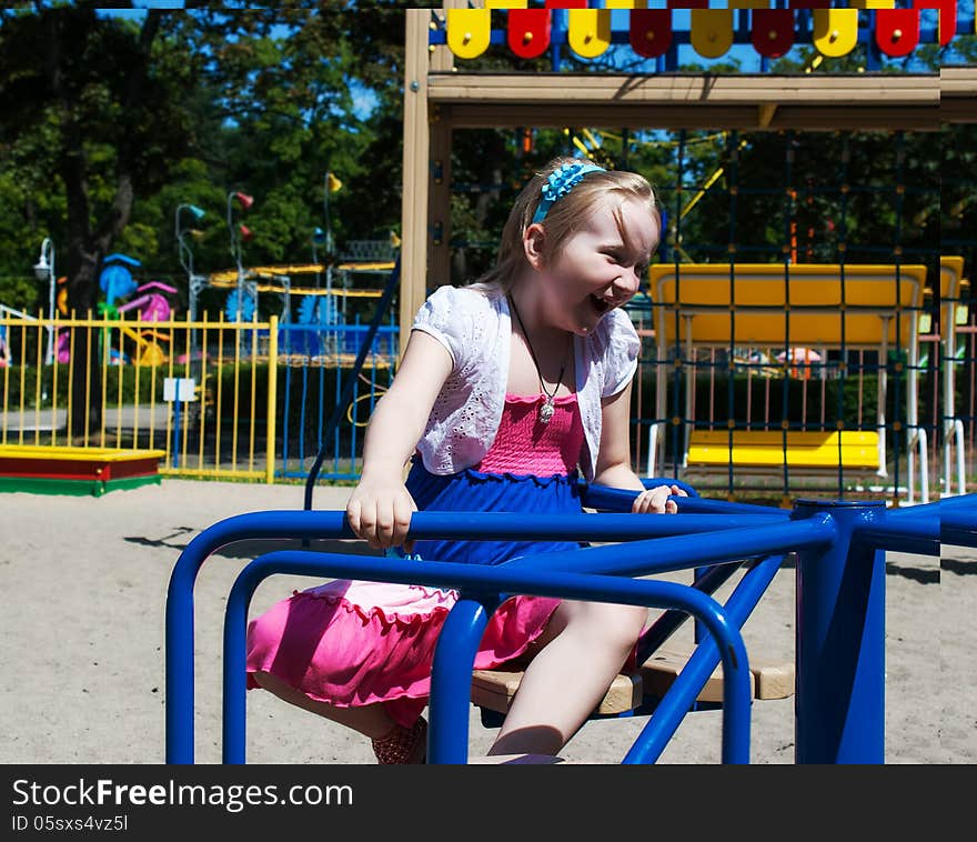 Girl riding on a carousel in the park