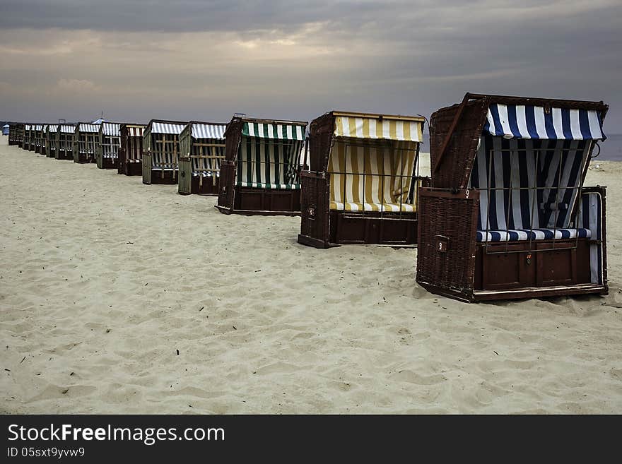 Wickerwork beach seats on the seashore against cloudy sky, Baltic Sea, Poland