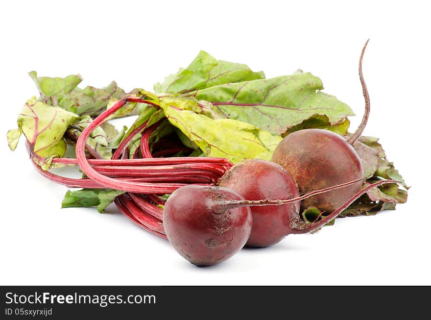 Heap of Fresh Raw Beetroots with Leafy Tops isolated on white background