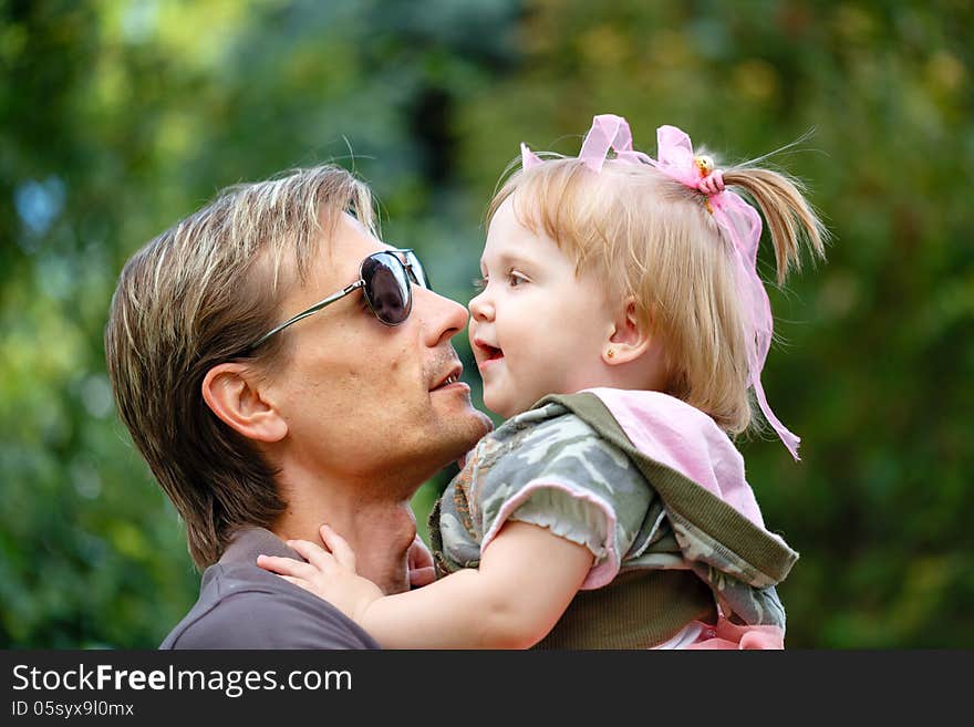 Father holds daughter on hands laughing. Father holds daughter on hands laughing