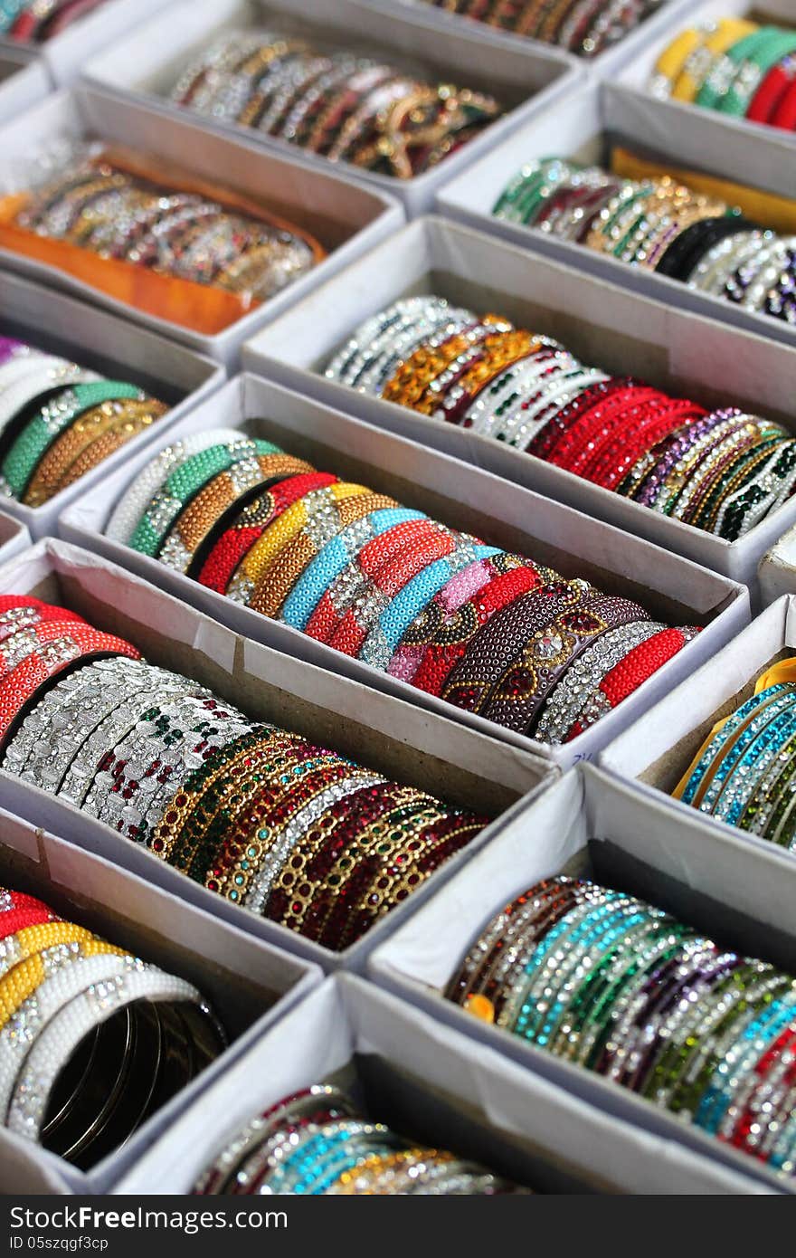 Collection of beautiful indian colorful bangles in vibrant colors. These pretty jewelry are made with beads and stones in vivid colors like red, blue, etc