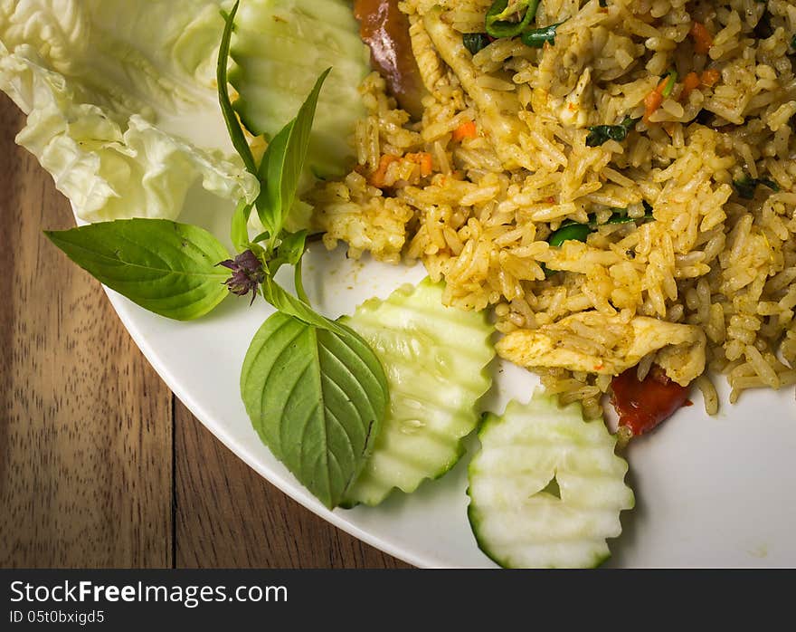 Close up fried rice with green curry chicken serve with vegetables