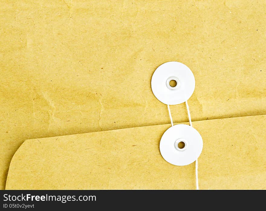 Close up of brown envelope and white string. Close up of brown envelope and white string