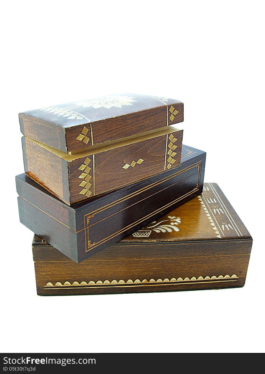 Wooden jewellery boxes/Three wooden jewellery boxes piled one on top on an other