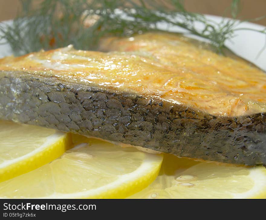 Fried salmon on a plate with lemon