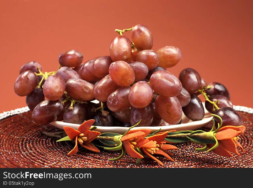 Plate Of Healthy Fruit, Red Grapes, In Red Brown Autumn Fall Setting