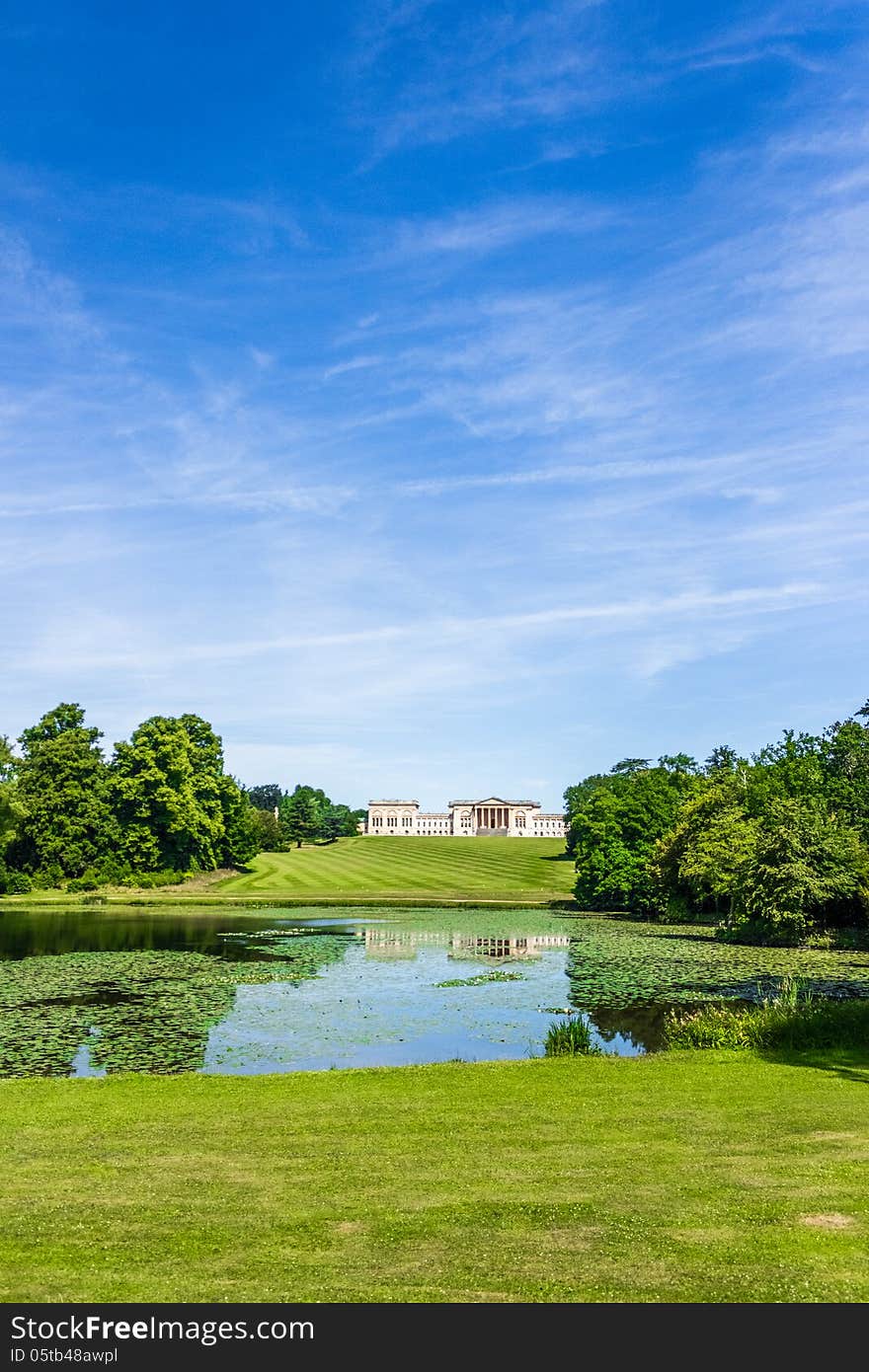 Portrait showing Stowe house and garden and reflection in lake with waterlilies