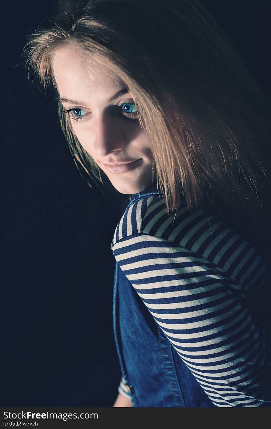 Portrait of beautiful thoughtful girl close up in the dark