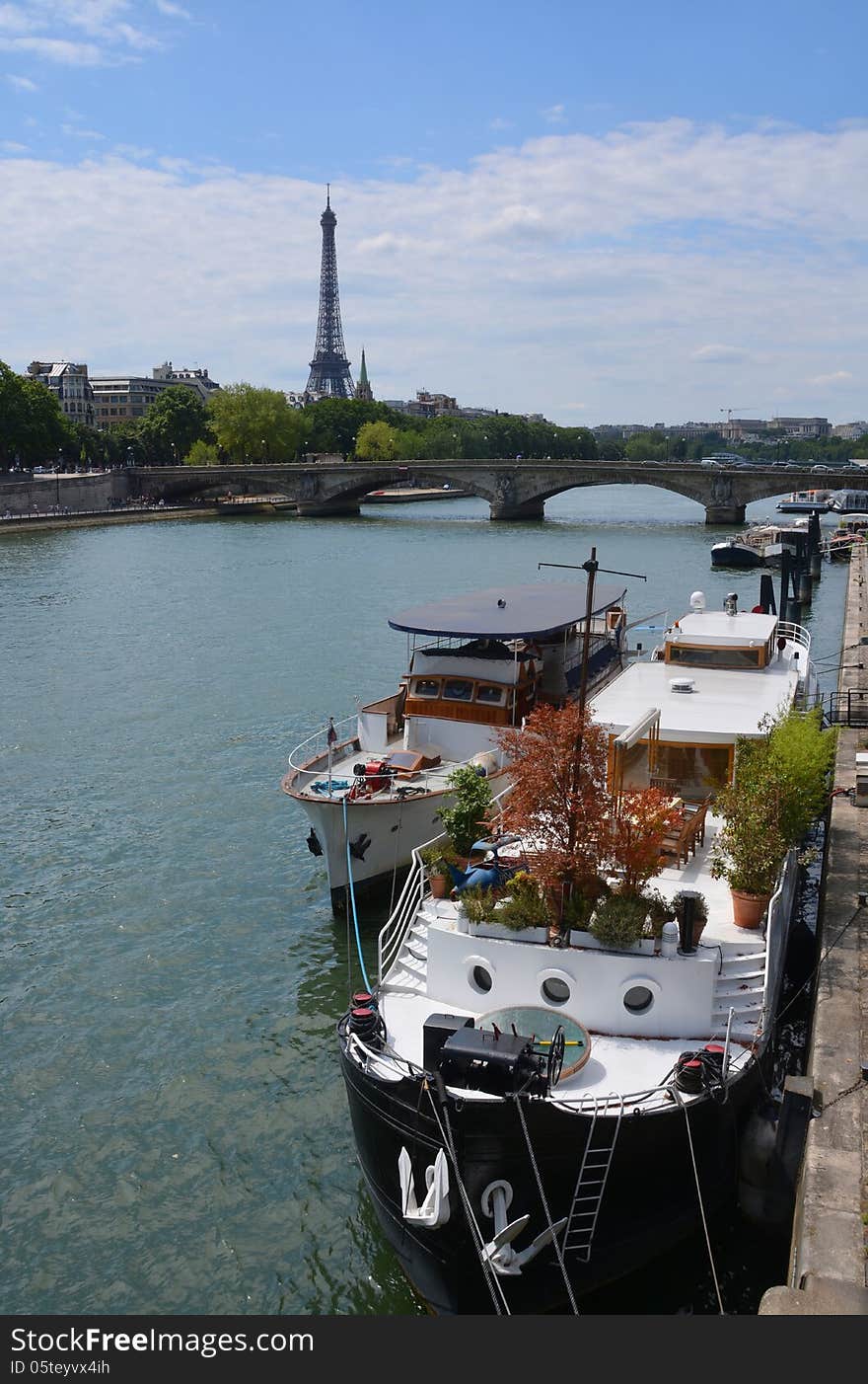 Party Boats Moored on The Seine River with Eiffel Tower in Backg