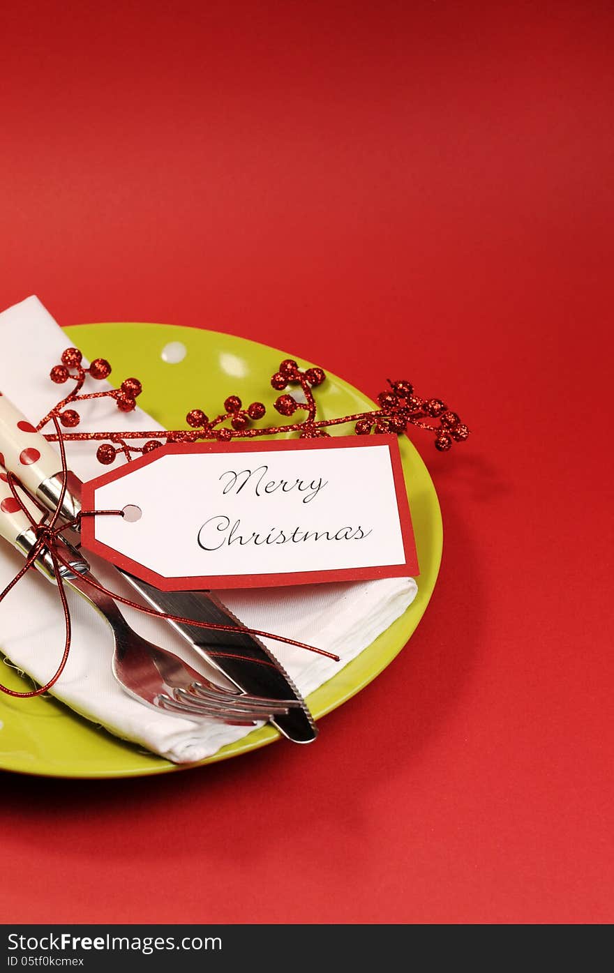 Modern trend lime green and red Merry Christmas table place setting. Vertical with copy space for your text here.