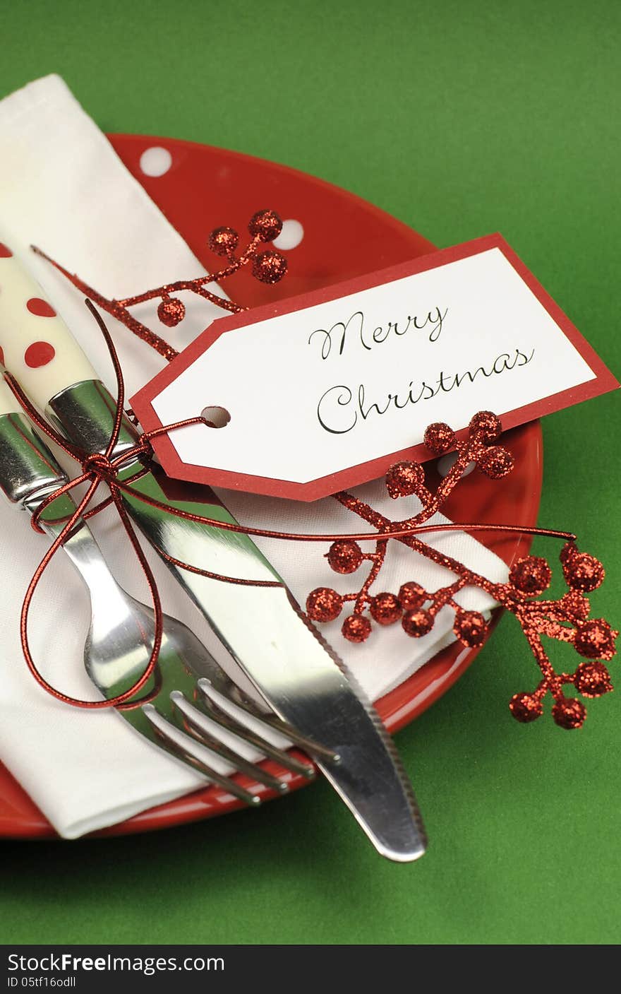 Traditional red and green Merry Christmas dinner or lunch table place setting - vertical with copy space for your text here. Traditional red and green Merry Christmas dinner or lunch table place setting - vertical with copy space for your text here.