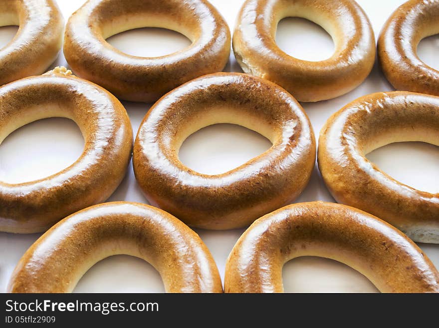 Some fresh delicious golden bagels as a background. Some fresh delicious golden bagels as a background