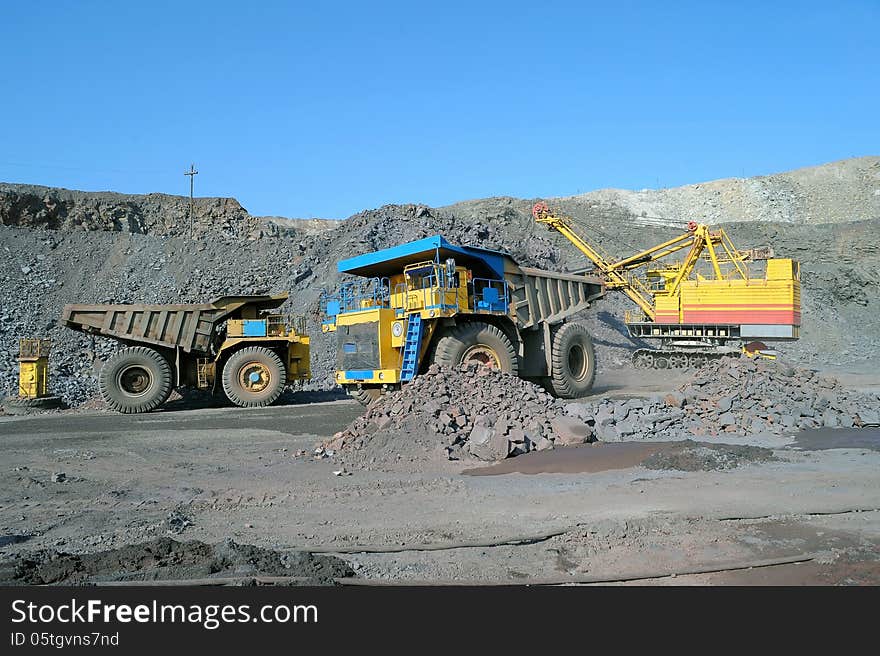 Loading of iron ore on very big dump-body truck