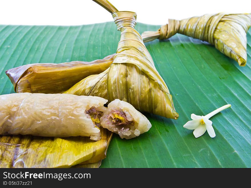 Sticky rice with banana fruit , wrapped in banana leaves traditional Thai. Sticky rice with banana fruit , wrapped in banana leaves traditional Thai.