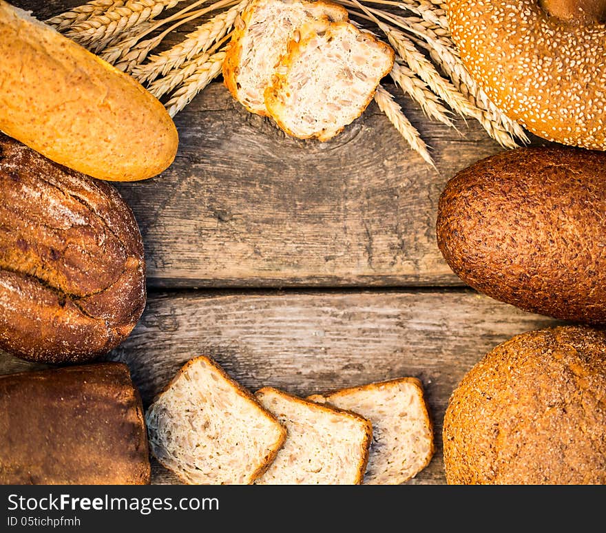 Homemade Bread And Wheat On The Wooden Table