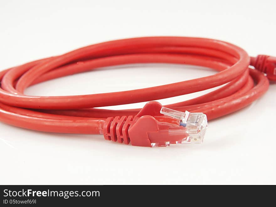 Red ethernet cable isolated against white