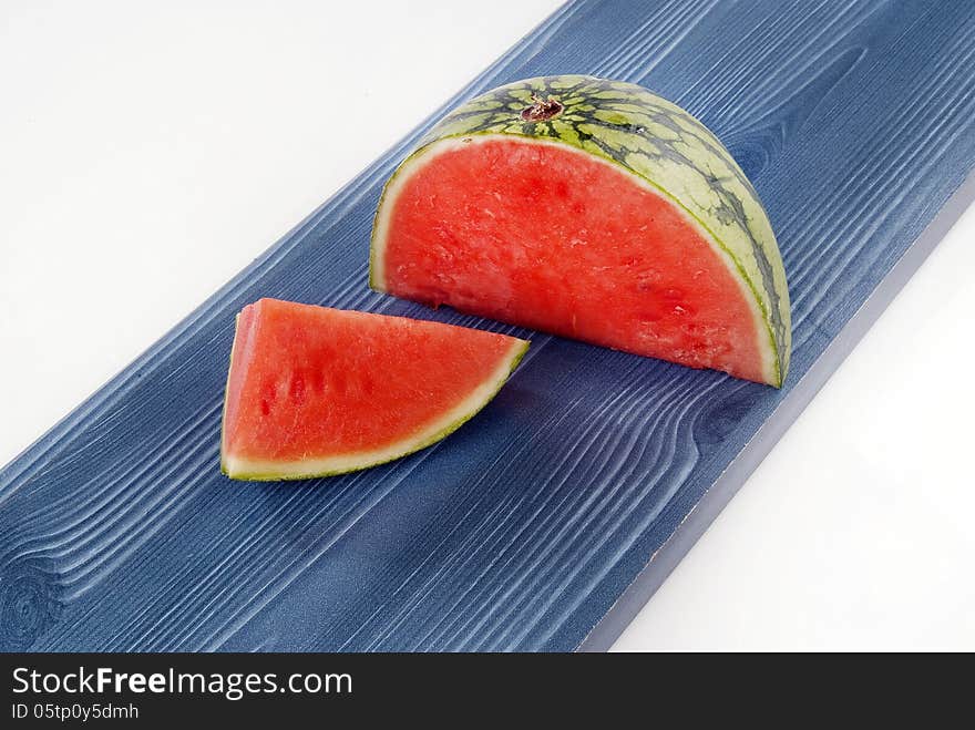 Fresh Melon quarters against coloured wood