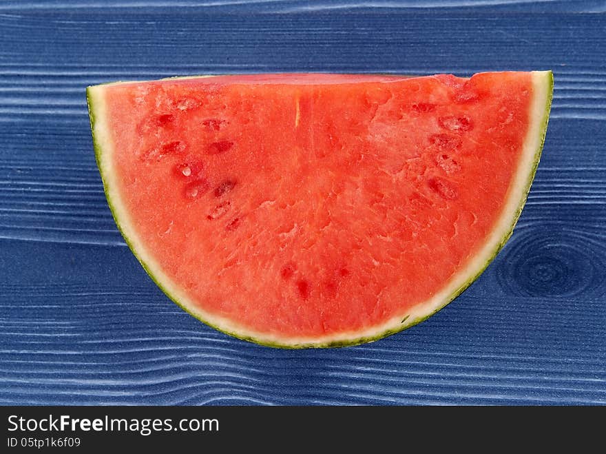 Fresh Melon against coloured wood