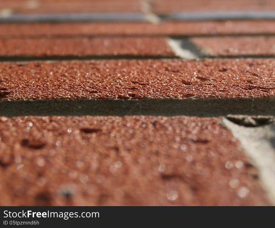 Close up tilted view of sunlit red brickwork. Close up tilted view of sunlit red brickwork.