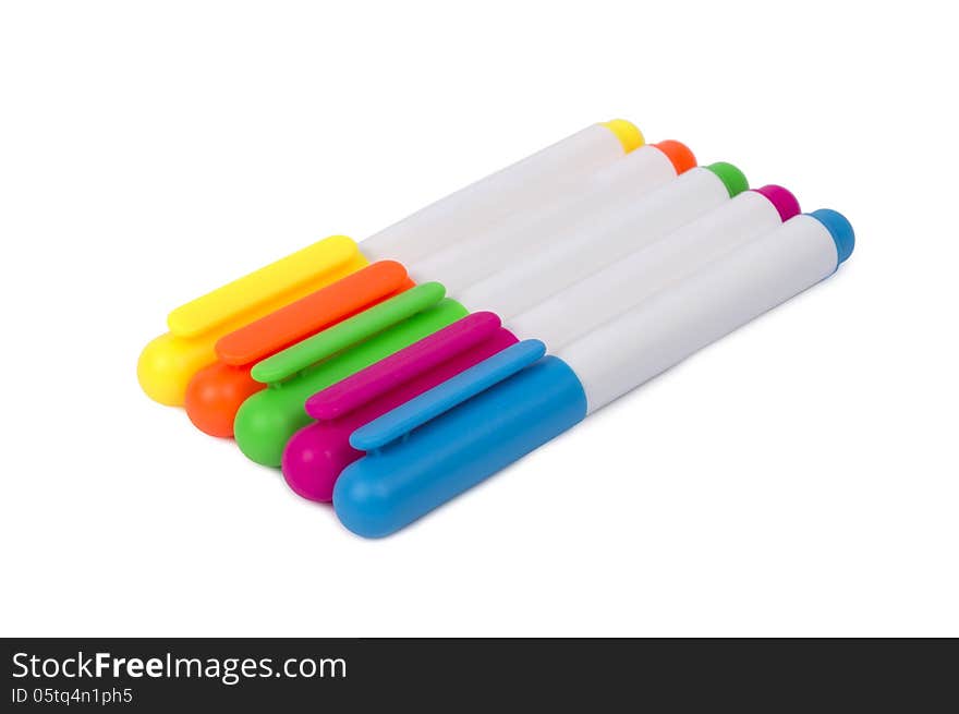 Row of colorful highlighters shot horizontally and isolated on a white background. Focus on the front. Row of colorful highlighters shot horizontally and isolated on a white background. Focus on the front.