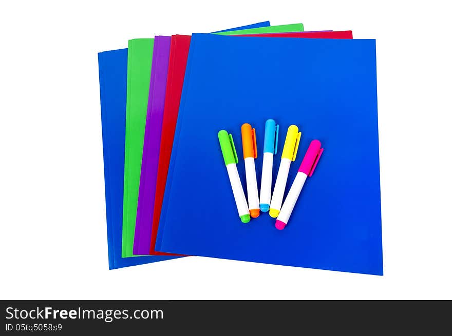 Stack of colorful folders for school or office and highlighters. Isolated on a white background. Stack of colorful folders for school or office and highlighters. Isolated on a white background.