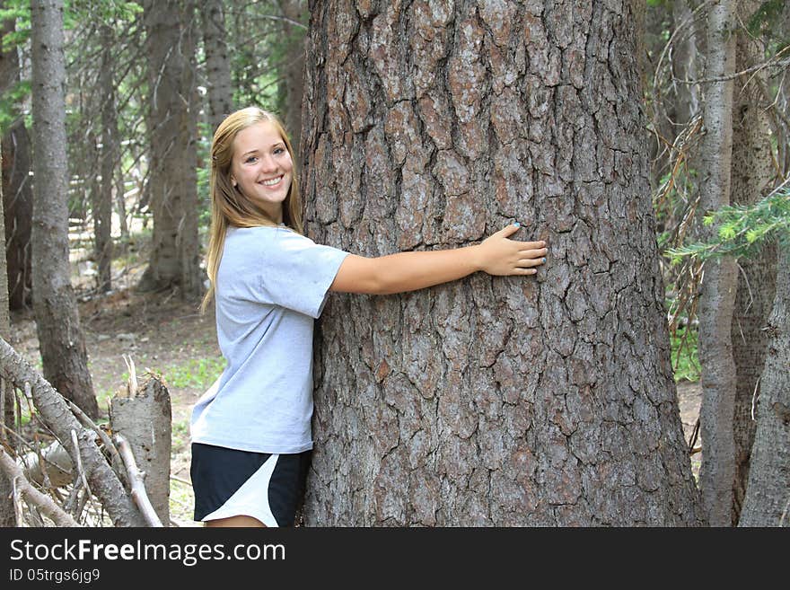 Athletic Teen Hugging Tree