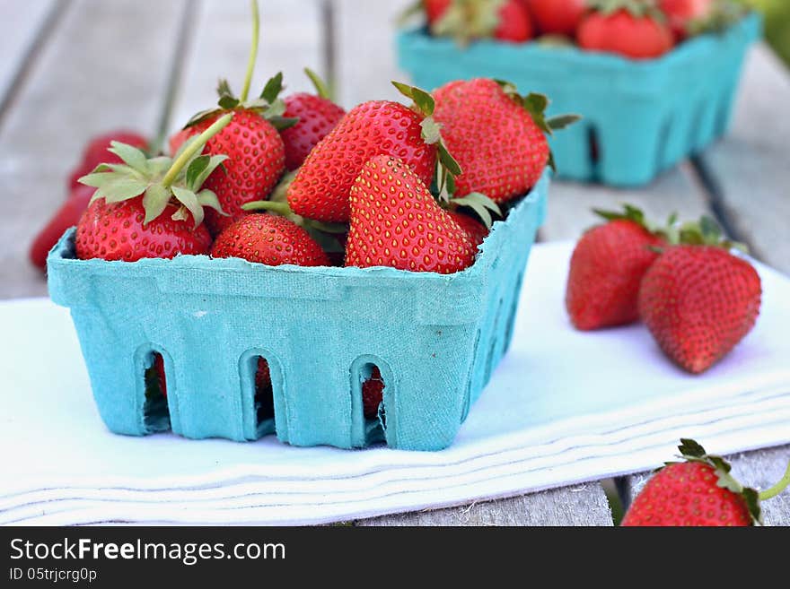 Blue basket filled with strawberries. Blue basket filled with strawberries.