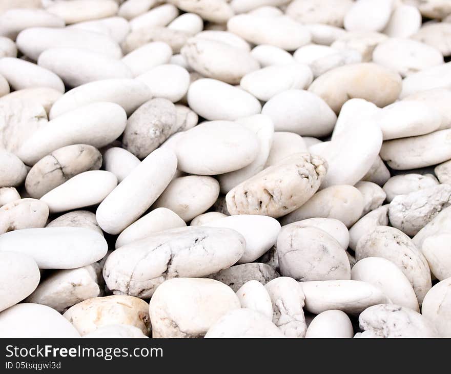 Sea stone naturally polished white rock pebbles background