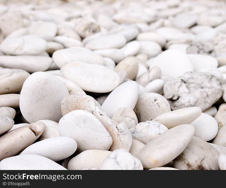 Sea stone naturally polished white rock pebbles background