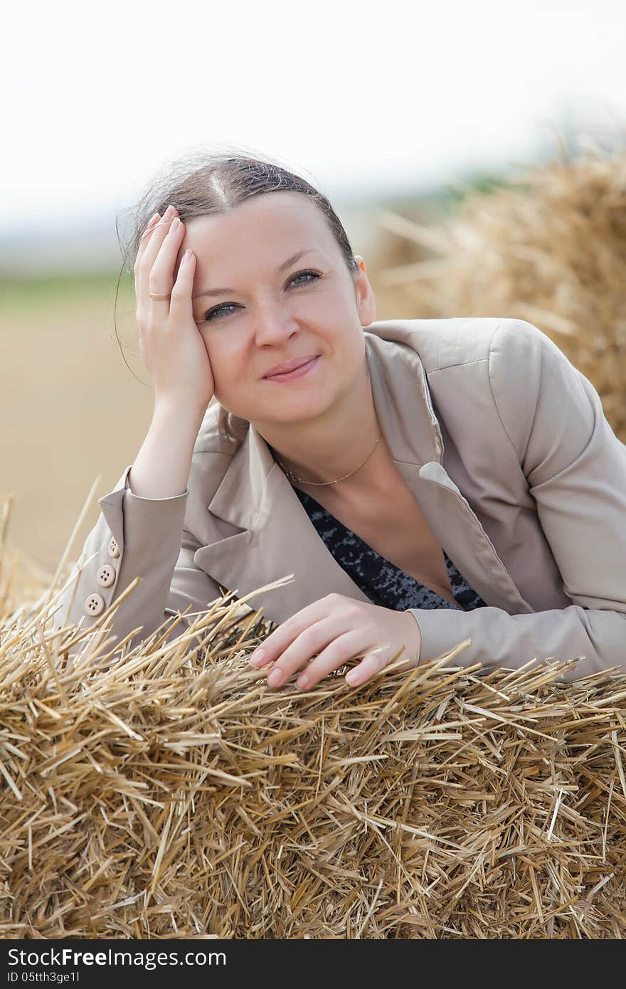 Portrait Of A Girl On The Stacks Of Wheat