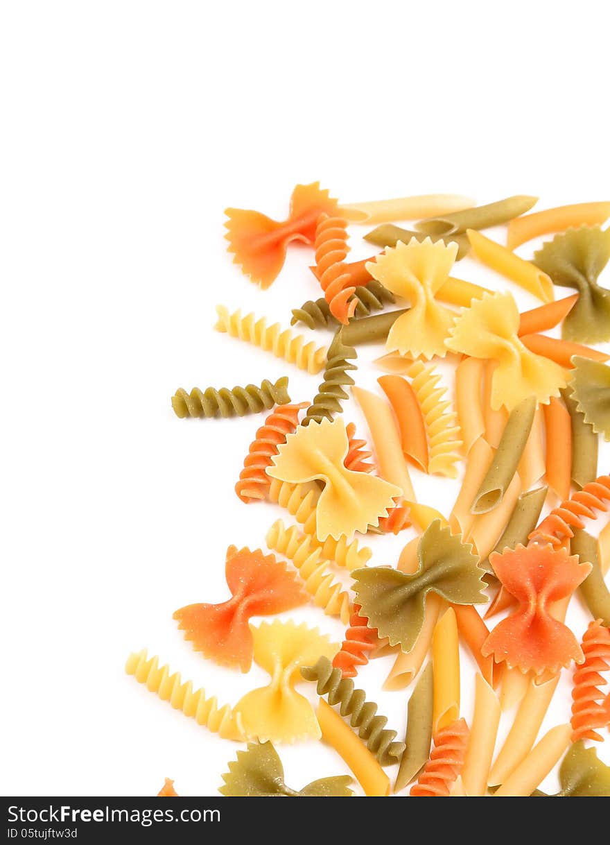 Different pasta in three colors on a white background