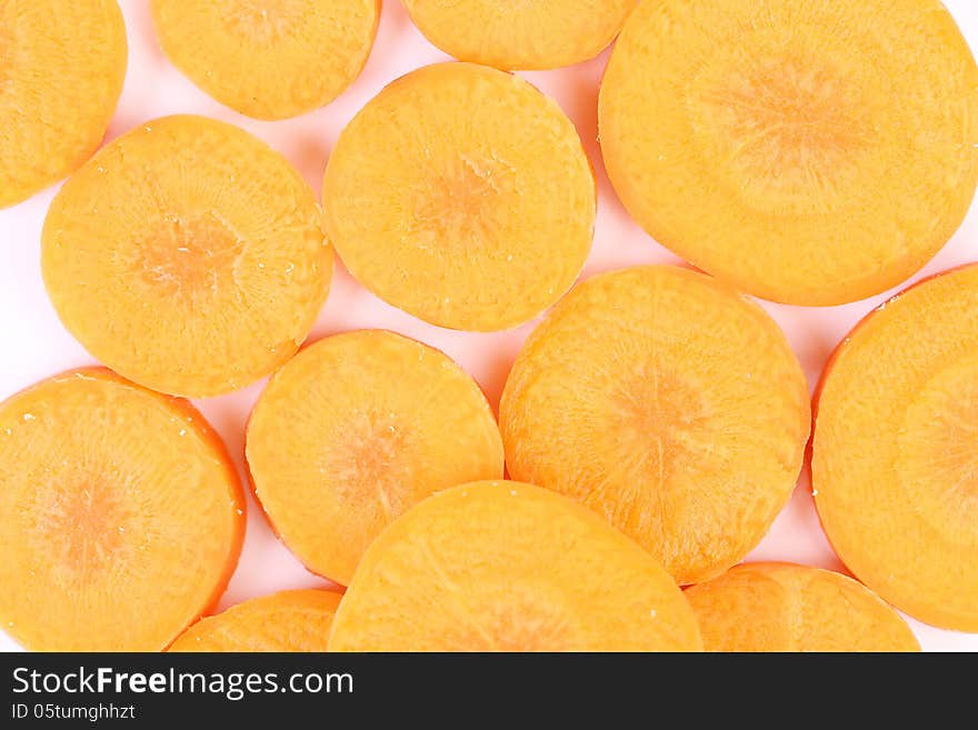 Raw carrot slices on a whole background