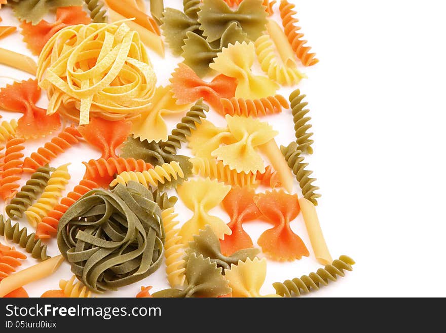 Tagliolini on a background of different pasta. White background.