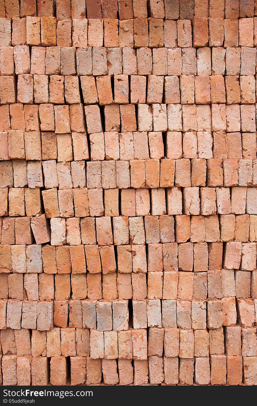 Big stack of red clay block for wall construction, texture