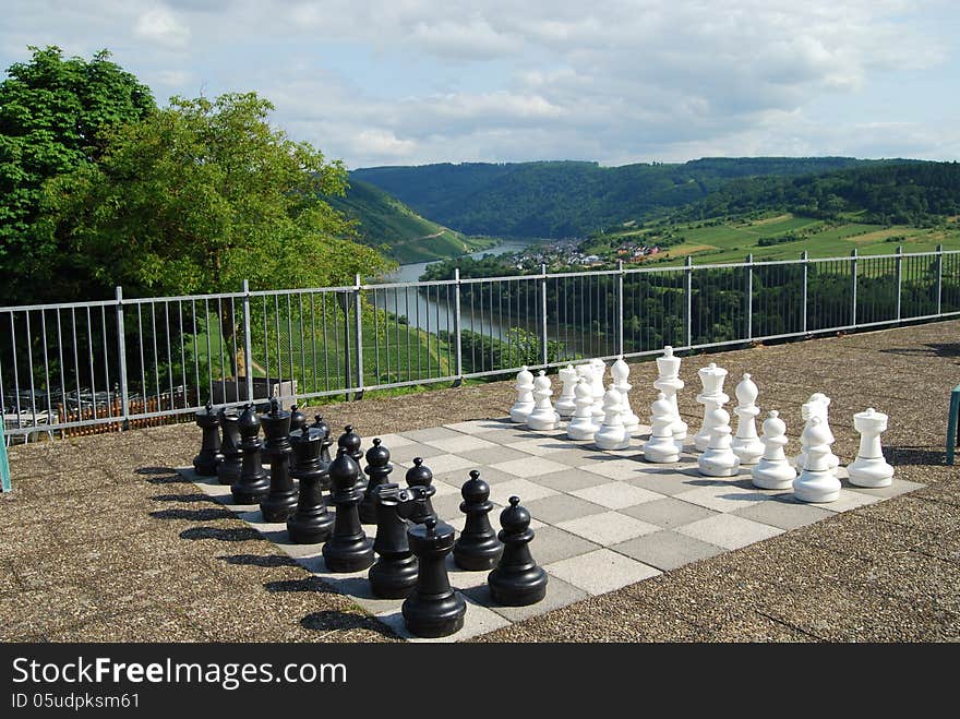 Outdoor chessboard at Marienburg Mosel Germany with vineyards beyond