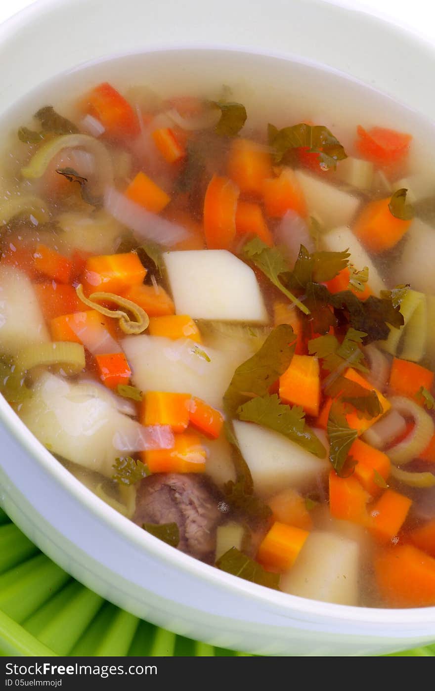 Simple Vegetable Soup with Potato, Carrot, Leek and Greens in Bowl closeup