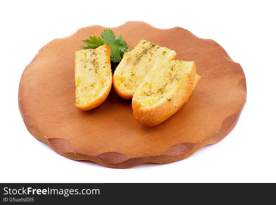 Arrangement of Three Slices of Garlic and Herb Bread on Wooden Cutting Board isolated on white background