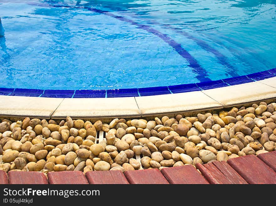 Luxury Resort Swimming Pool low angle on curved edge of a luxury resort swimming pool. Luxury Resort Swimming Pool low angle on curved edge of a luxury resort swimming pool