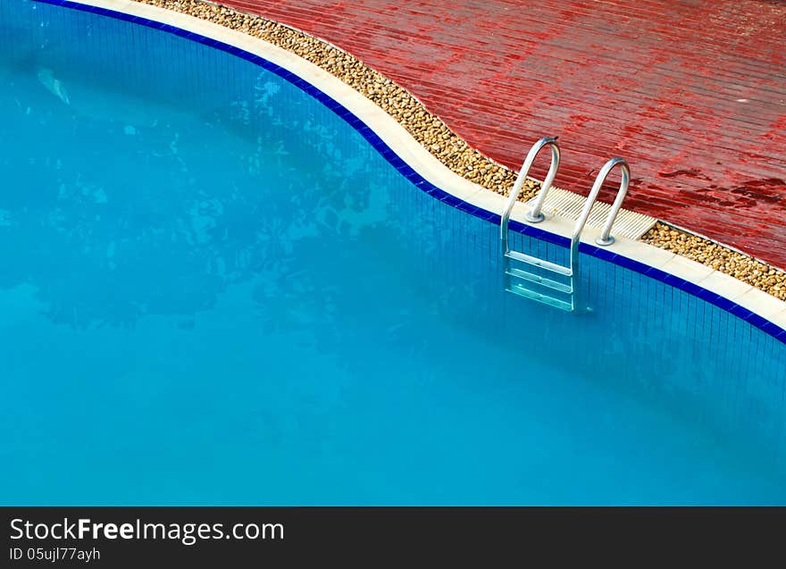 Luxury Resort Swimming Pool high angle on curved edge of a luxury resort swimming pool. Luxury Resort Swimming Pool high angle on curved edge of a luxury resort swimming pool