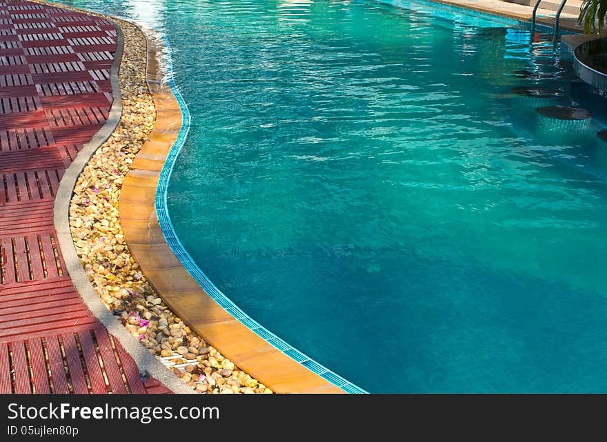 Luxury Resort Swimming Pool low angle on curved edge of a luxury resort swimming pool. Luxury Resort Swimming Pool low angle on curved edge of a luxury resort swimming pool